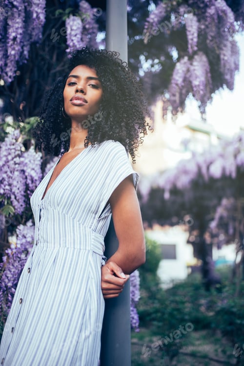 Preview: Young black woman surrounded by flowers