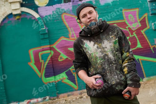Preview: Guy standing against graffiti artwork