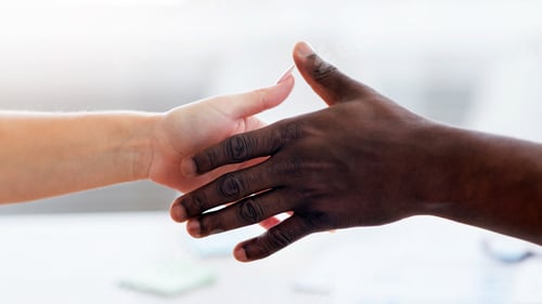 Preview: International partnership concept. Unrecognizable business partners extending hands for handshake