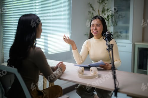 Preview: Woman recording podcast interview with guest