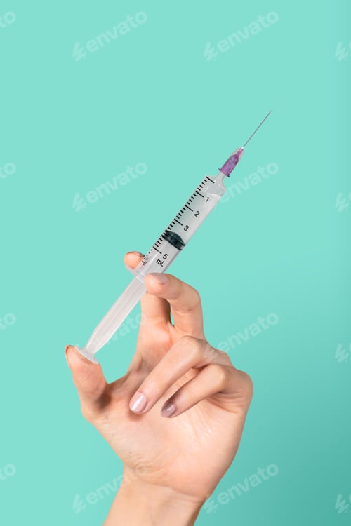 Preview: Medical injection in a feminine hand