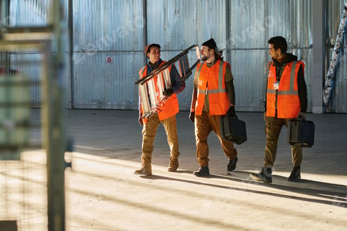 Preview: Three happy engineers of warehouse with stepladder and toolboxes