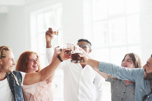 Preview: Party all day. Teammates drinking whiskey and laughing because of successful deal