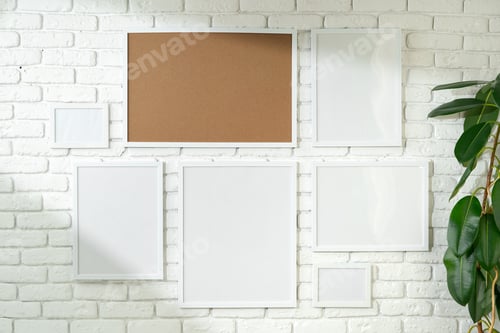 Preview: Varied Sized Photo Frames Displayed on a White Brick Wall
