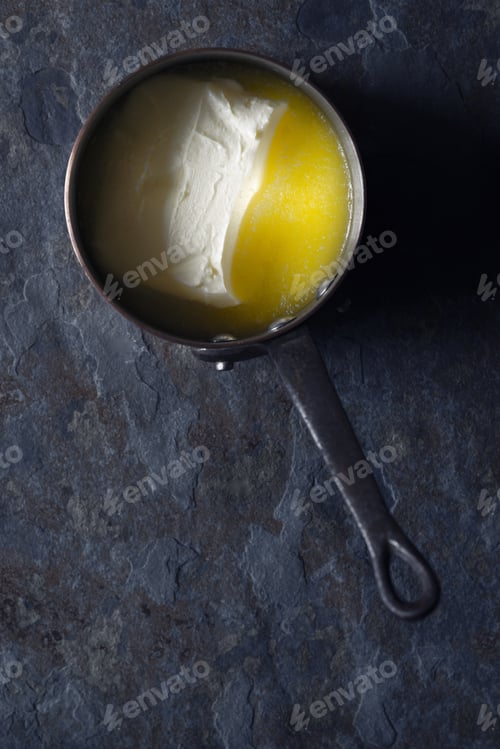 Preview: Melted butter in the stewpan on the stone background vertical