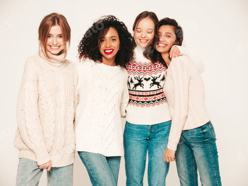 Preview: Portrait of four beautiful women posing in studio