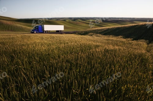 Preview: commercial truck driving though wheat fields of eastern Washington, USA at sunset.
