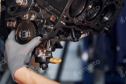 Preview: Professional repairman works with broken automobile engine