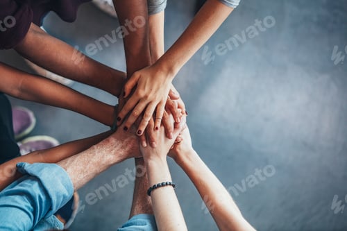 Stack of hands showing unity and teamwork