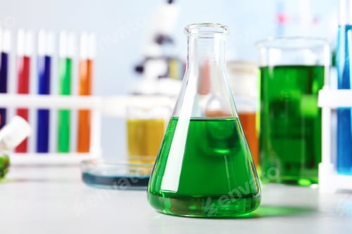 Preview: Conical flask and other glassware on table in chemistry laboratory. Space for text