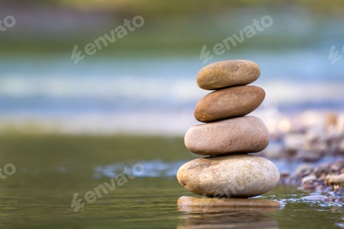 Preview: Close-up abstract image of wet rough natural brown uneven different sizes and forms stones balanced