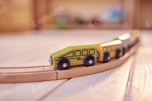 Preview: Wooden toy train on a track with defocused children's room in backdrop