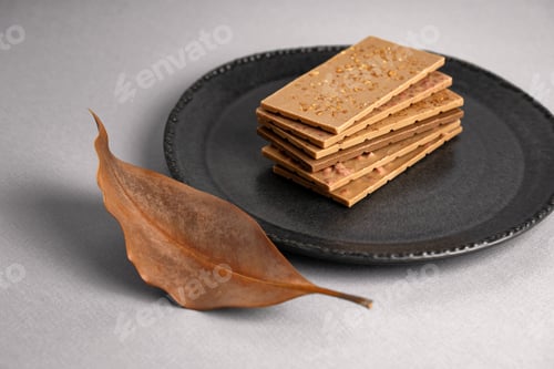 Preview: white chocolate pieces stacked over each other on plate. copy space text area