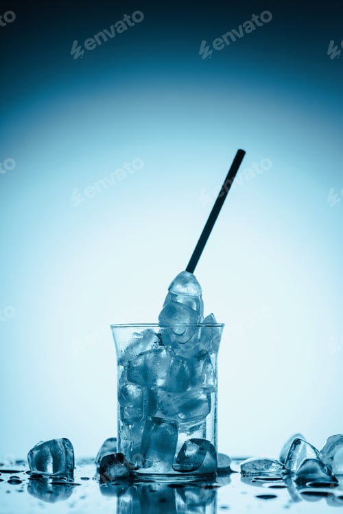 Preview: melting ice cubes in glass with straw, on white