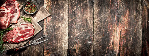 Preview: Raw meat background. Pieces of raw steak with spices and herbs. On wooden background.