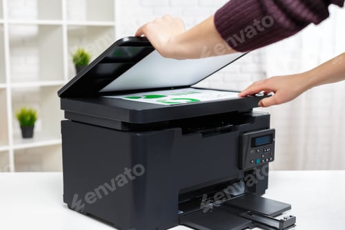 Preview: Person operates a printer scanner in an office setting during the day