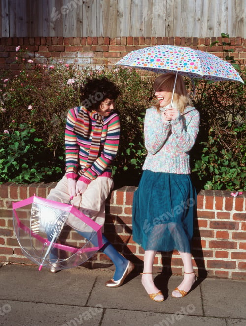 Preview: Two friends with umbrellas