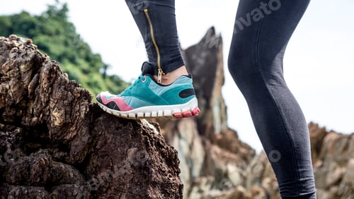 Preview: The girl in sportswear on the rocks
