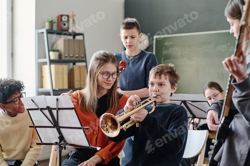 Preview: Young Teacher Working With School Orchestra