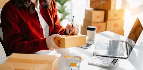 Preview: Young woman holding a smartphone showing payment success and credit card with yellow parcel box