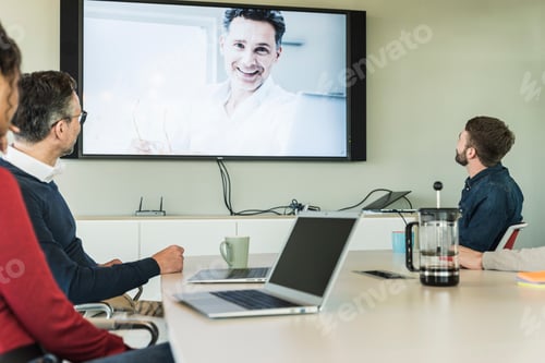 Preview: Business people having a video conference in boardroom