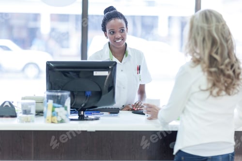 Preview: Customer in pharmacy getting assistance at till