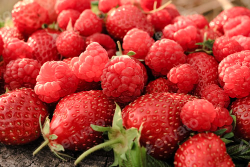 Preview: Heap of strawberries, raspberries on natural wooden background. New fresh harvest. Organic food. N