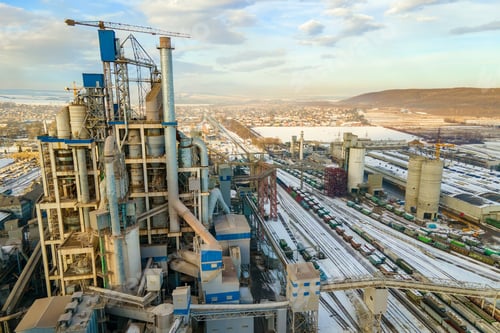 Preview: Aerial view of cement plant with high factory structure at industrial production area.