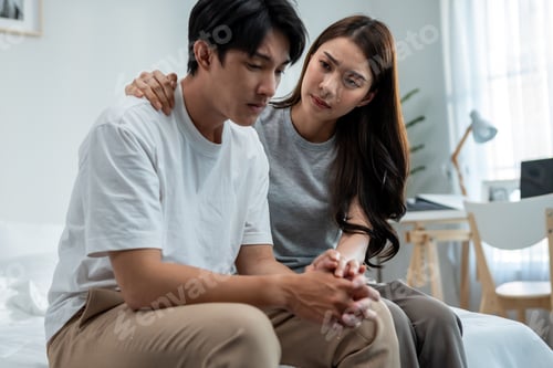 Preview: Asian wife comforting her husband crying with tears for life problem.
