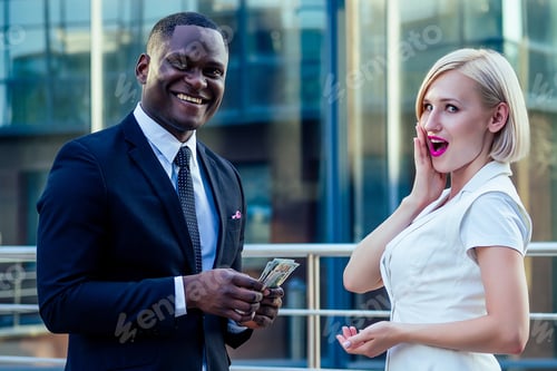 Preview: handsome Afro businessman in a stylish black suit with attractive blonde