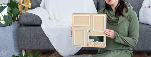 Preview: Happy woman in house holds in hands photo frame with figure at home template and key in interior. Dr