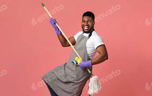 Preview: Portrait Of Funny Black Man In Apron With Mop In Hands