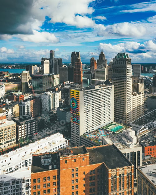 Preview: Vertical picture of buildings under a cloudy sky and sunlight in Detroit in Michigan, the USA