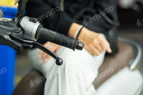 Preview: Close-up of Motorcycle Handlebar and Rider's Hand