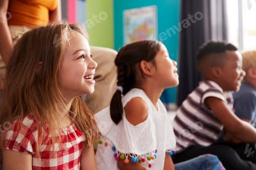 Preview: Group Of Elementary School Pupils Sitting On Floor Listening To Teacher