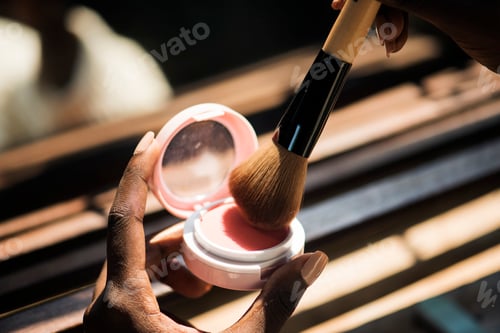 Preview: Closeup of woman using blush on