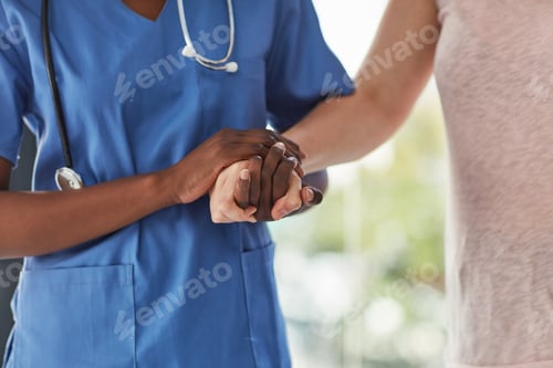 Vista previa: Closeup shot of a medical practitioner holding a patients hand in comfort