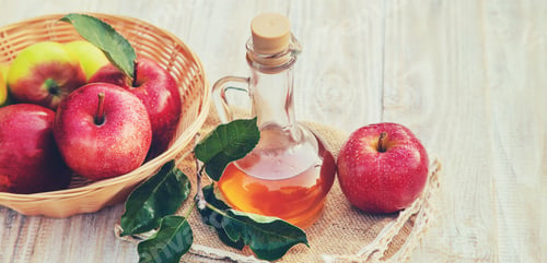 Preview: Apple cider vinegar in a bottle. Selective focus.