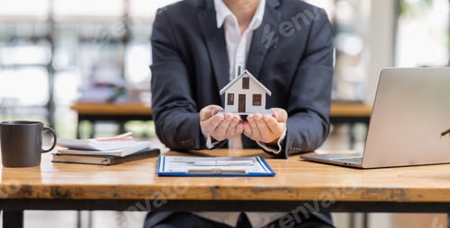 Preview: house model with businessman signs a purchase contract or mortgage for a buy and sell home insurance