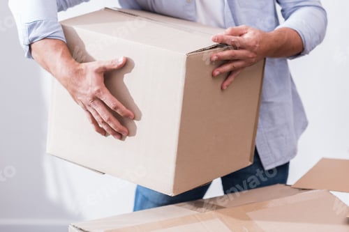Preview: partial view of man holding cardboard box in hands