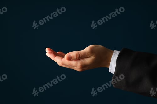 Preview: Businessman's hand close-up on a dark background