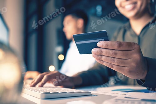 Preview: Hands, computer and credit card for ecommerce, online shopping or banking at night on office desk.