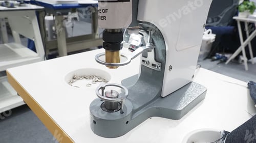 Preview: A button press machine used in garment manufacturing