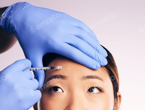 Preview: Face skincare, forehead injection and Asian woman in studio isolated on a white background. Cosmeti