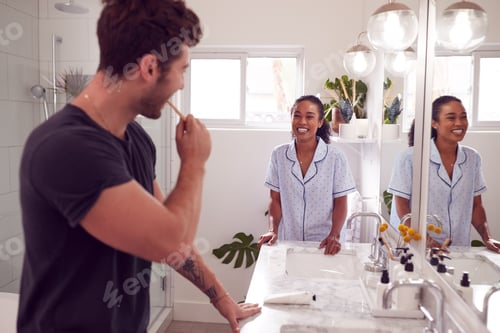 Preview: Couple Wearing Pyjamas Standing In Bathroom At Sink Brushing Teeth In The Morning
