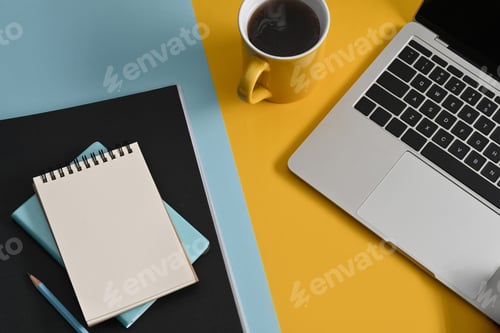 Preview: Top view notepad, computer laptop and coffee cup on colorful background.