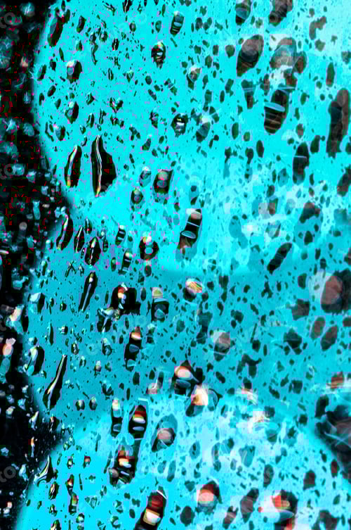 Preview: Macro shot of a window glass with waterdrops in blue bright lights