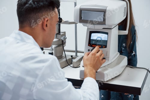 Preview: Oculist tests vision of patient by using special modern machine