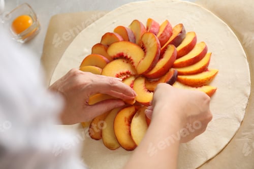 Preview: Woman making peach pie at table, closeup