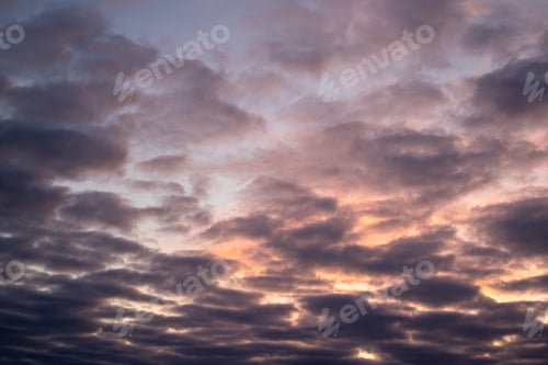 Preview: big, pink cumulonimbus clouds in a stormy sky at sunset. Moody sunset or sunrise sky.